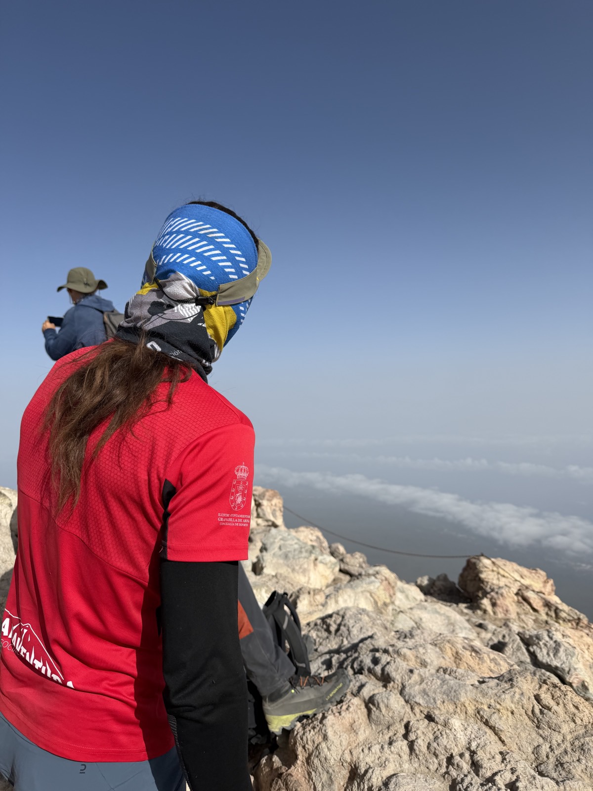 Hiker looking out over the sea of clouds near the summit of Teide