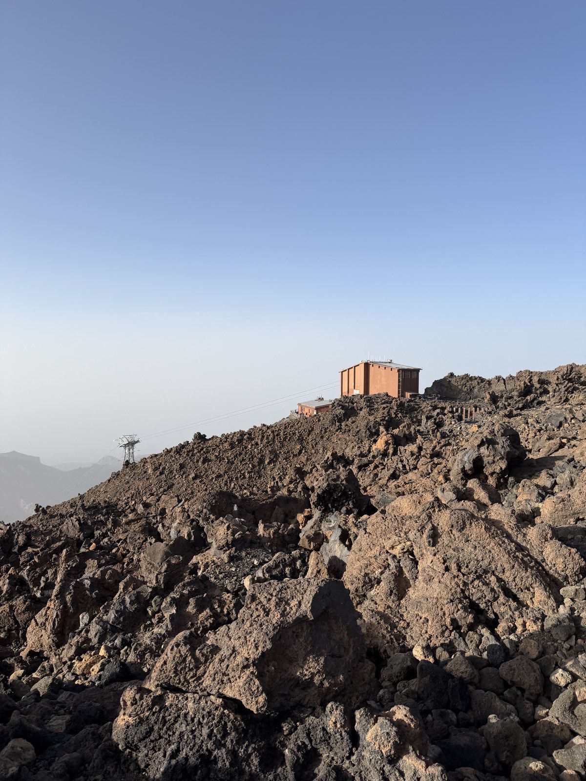 Small stone shelter building on the rocky upper slope of Teide near La Rambleta